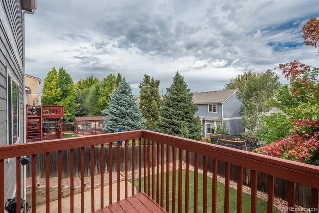 a view of a balcony with wooden fence