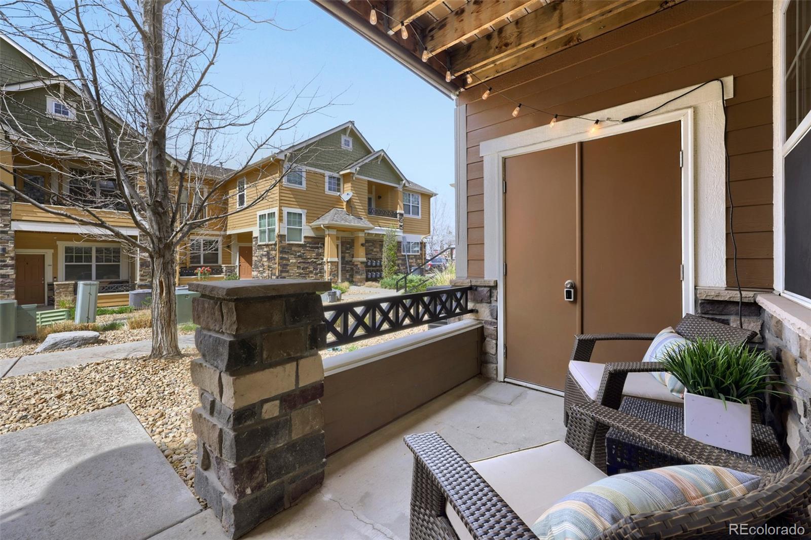 7130 Simms Street, Unit 107 Arvada, CO 80004 - Photo 2 of 29 a view of a chairs and table in the patio
