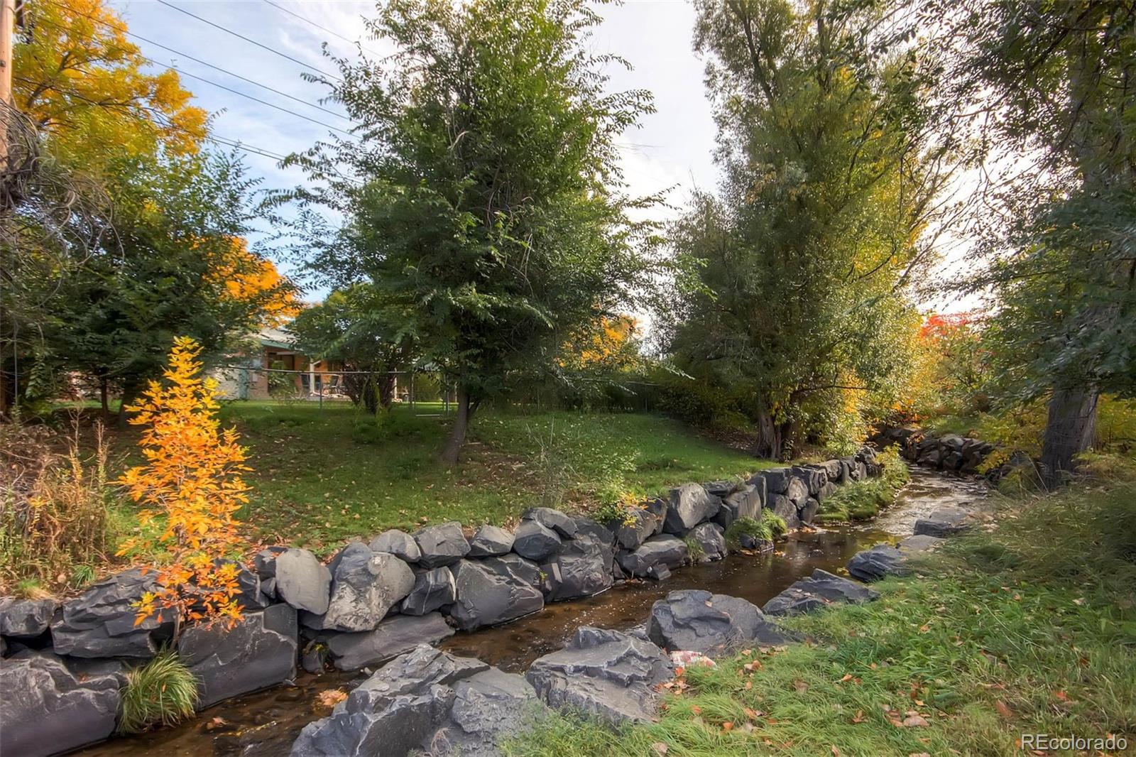 7130 Simms Street, Unit 107 Arvada, CO 80004 - Photo 23 of 29 a view of lake with green space