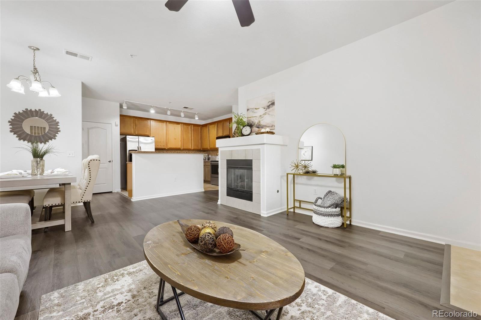 7130 Simms Street, Unit 107 Arvada, CO 80004 - Photo 6 of 29 a living room with furniture and a wooden floor