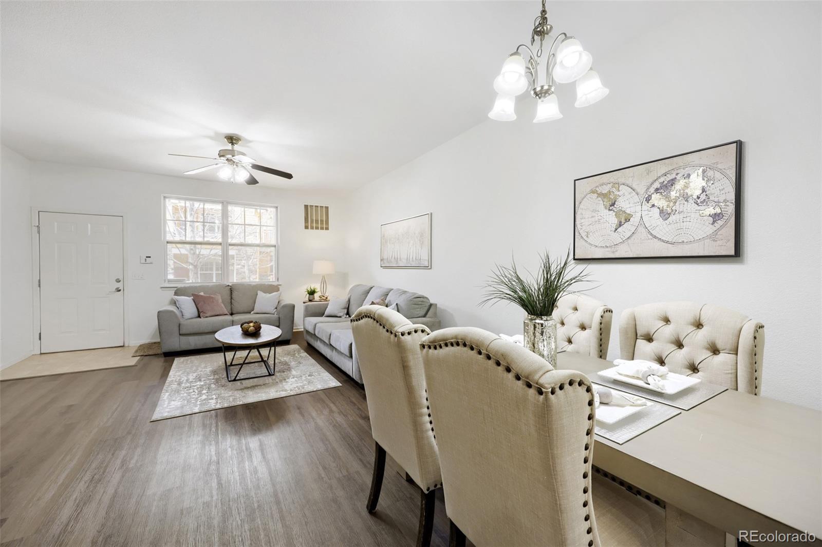 7130 Simms Street, Unit 107 Arvada, CO 80004 - Photo 7 of 29 a living room with furniture and a large window