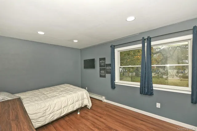 a bedroom with bed and window