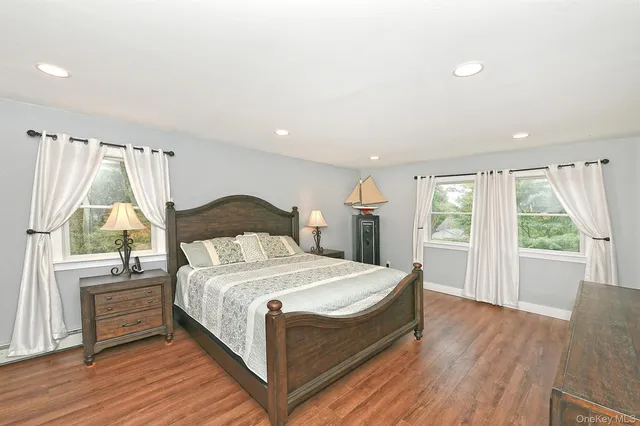 a bedroom with a bed and a large window