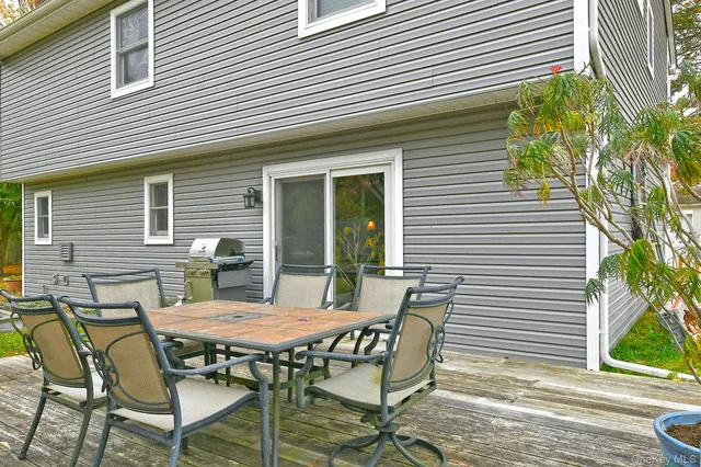 a view of a patio with table and chairs and potted plants