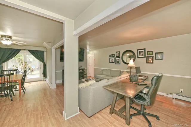 a view of a dining room with furniture and wooden floor