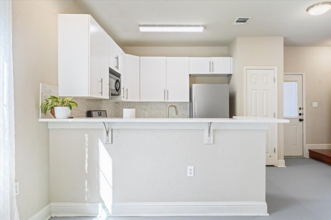 1210 East M. Franklin Avenue, Unit B Austin, TX 78721 - Photo 12 of 32 The kitchen combines style and functionality with modern cabinetry and stainless steel appliances.