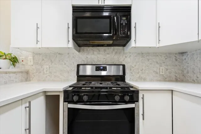 a kitchen with a sink and a stove top oven