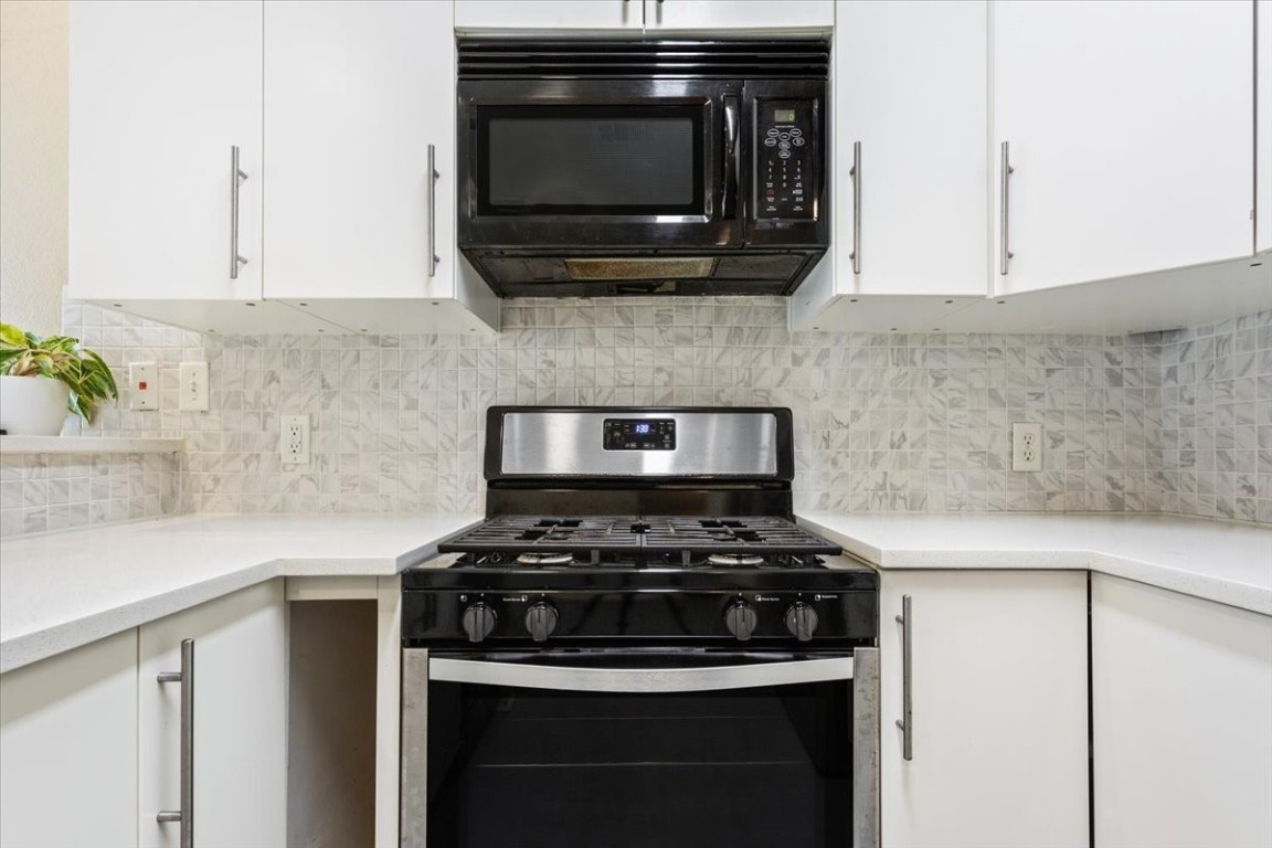 1210 East M. Franklin Avenue, Unit B Austin, TX 78721 - Photo 14 of 32 a stove top oven sitting inside of a kitchen
