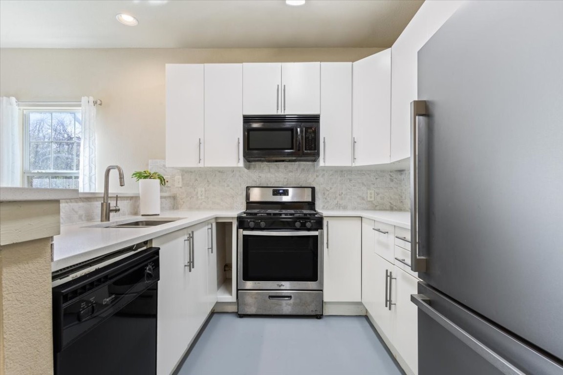 1210 East M. Franklin Avenue, Unit B Austin, TX 78721 - Photo 15 of 32 a kitchen with a sink and a stove top oven