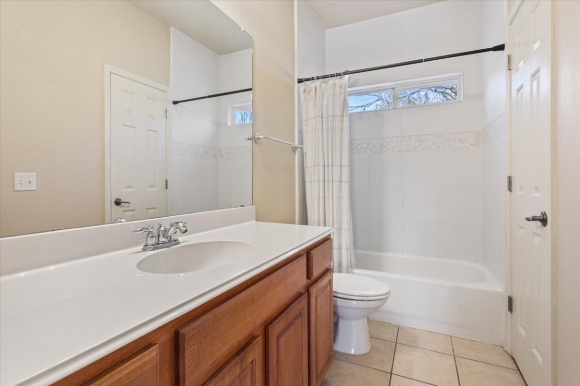 1210 East M. Franklin Avenue, Unit B Austin, TX 78721 - Photo 19 of 32 a bathroom with a sink a toilet and shower