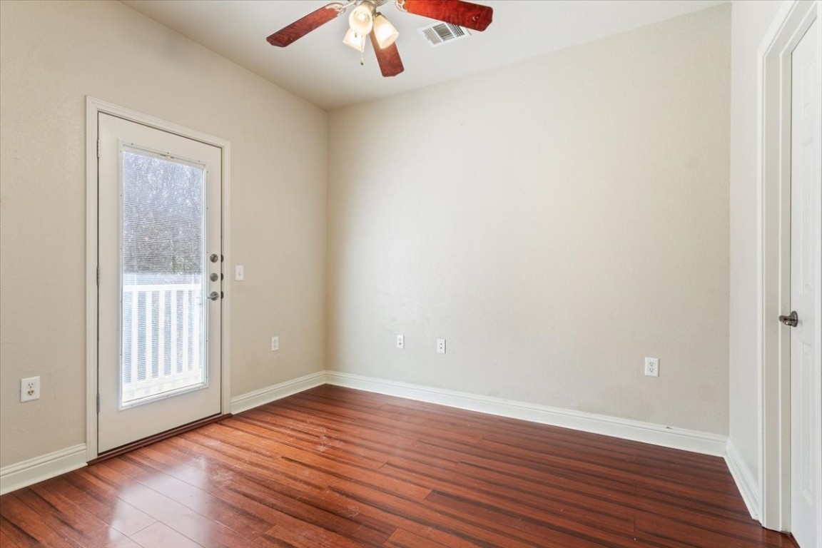 1210 East M. Franklin Avenue, Unit B Austin, TX 78721 - Photo 21 of 32 a view of an empty room with wooden floor and a window