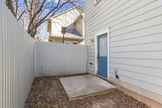 a view of a yard with wooden fence and a large tree