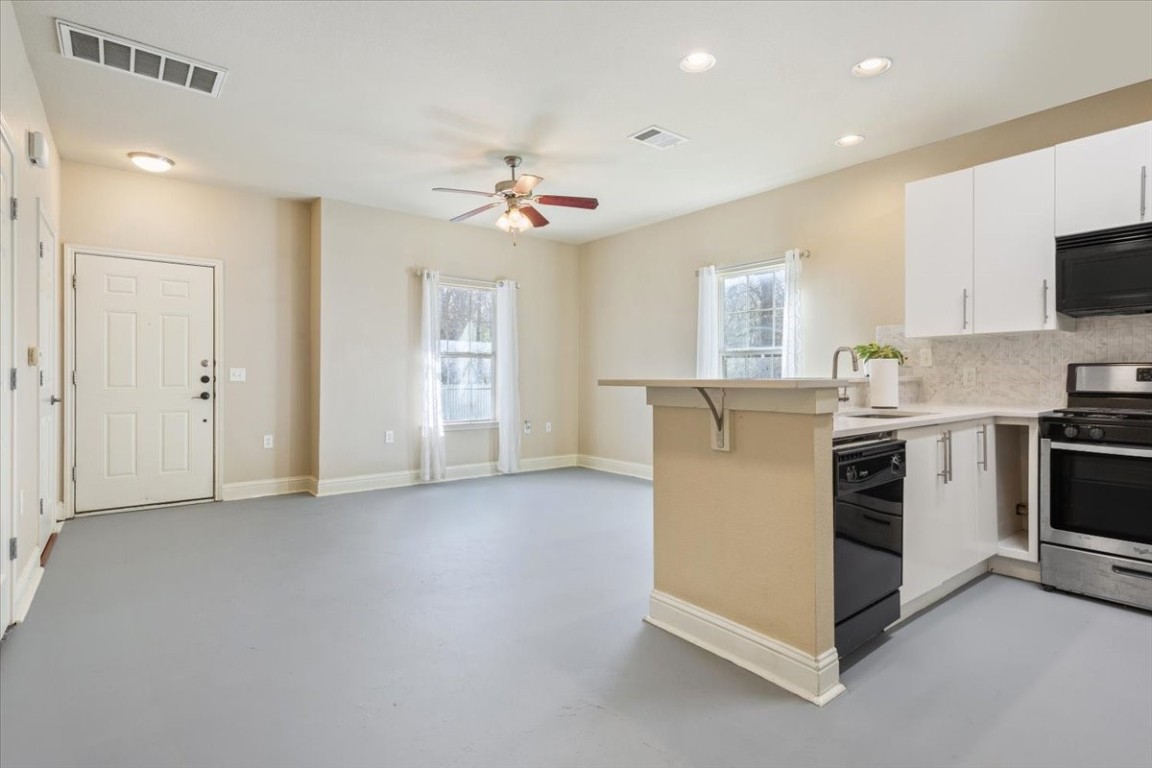 1210 East M. Franklin Avenue, Unit B Austin, TX 78721 - Photo 10 of 32 a kitchen with stainless steel appliances a stove a sink and a refrigerator