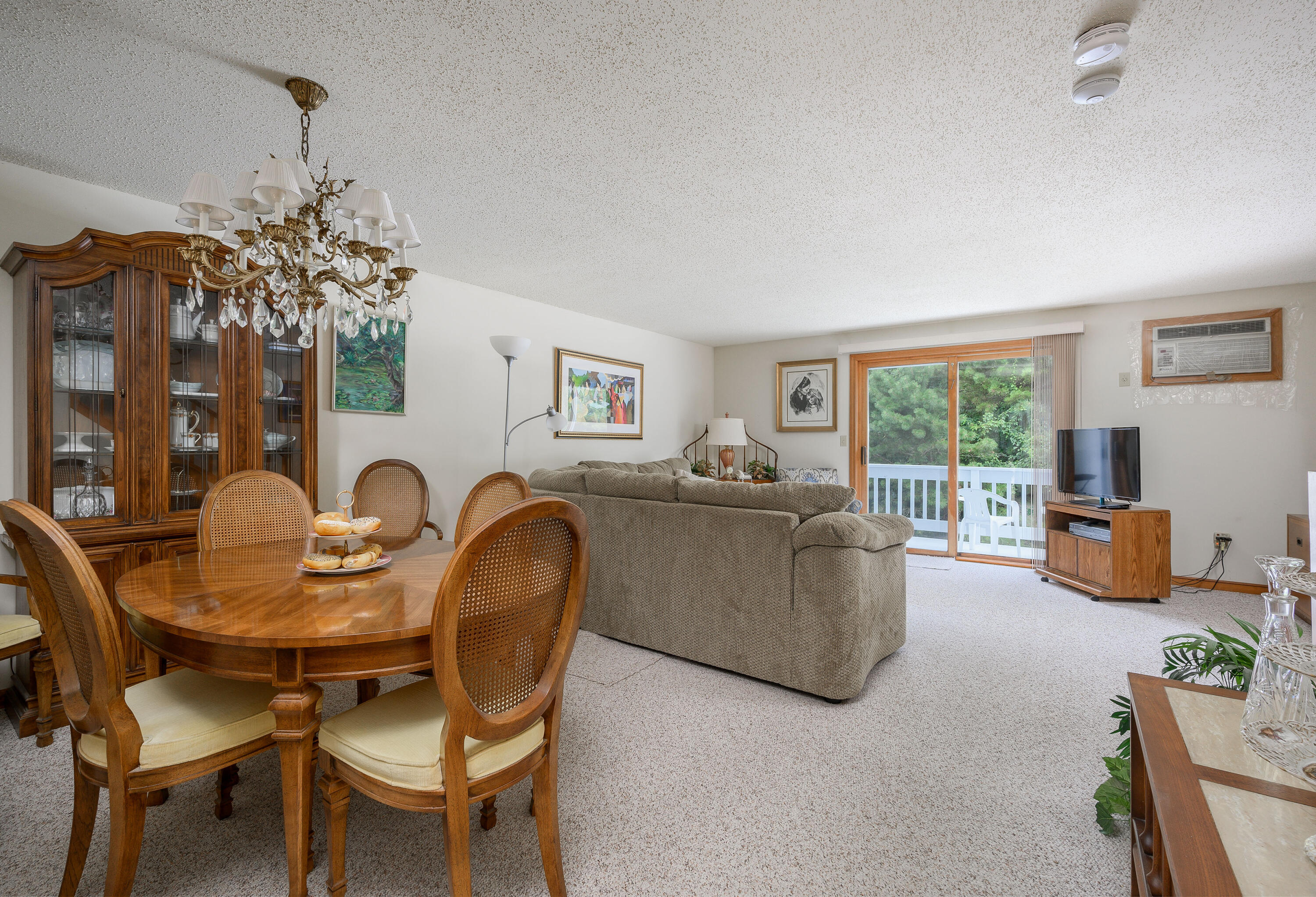 174 Lowell Road, Unit N102 Mashpee, MA 02649 - Photo 11 of 35 a living room with furniture and a large window