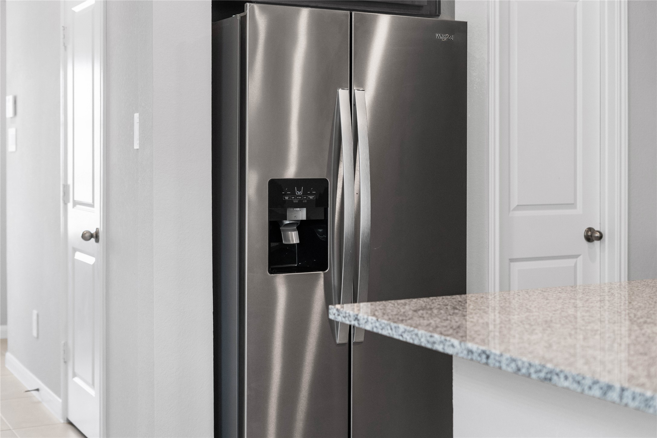 19555 Montgomery Rdg Way Montgomery, TX 77316 - Photo 17 of 38 Kitchen comes equipped with a side-by-side Whirlpool refrigerator.