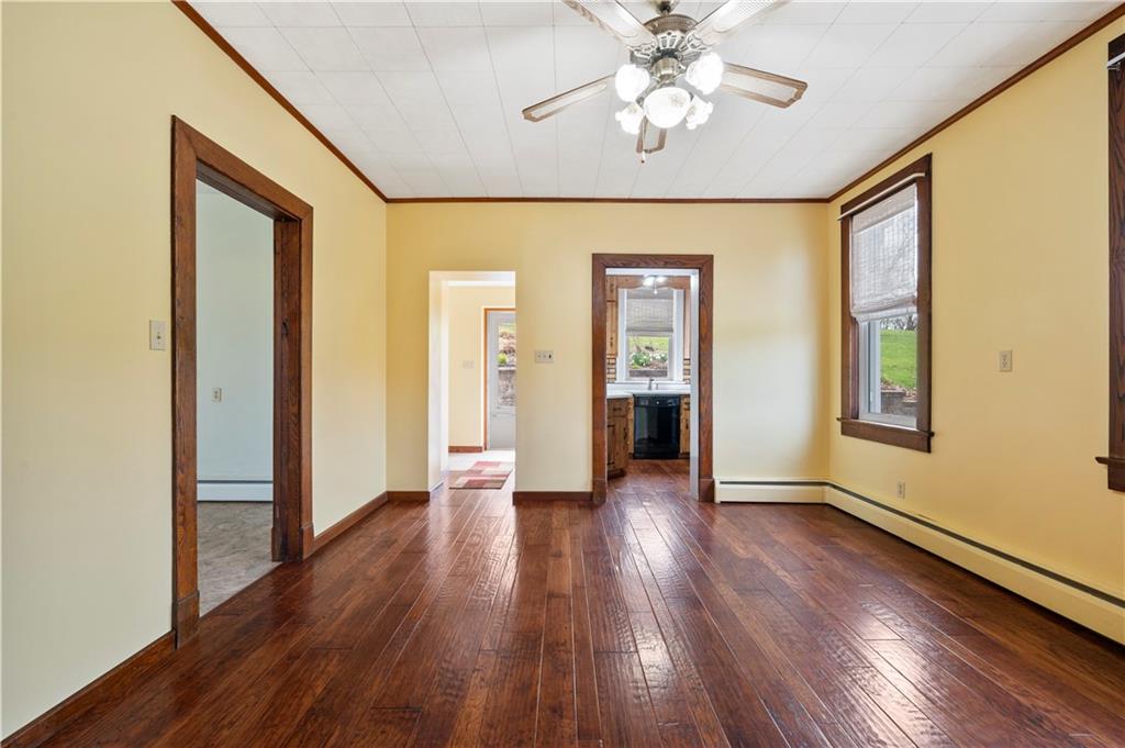 147 Ralston Road Sarver, PA 16055 - Photo 17 of 39 an empty room with wooden floor chandelier fan and windows