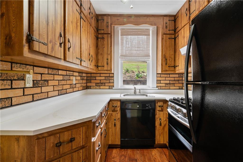147 Ralston Road Sarver, PA 16055 - Photo 18 of 39 a kitchen with stainless steel appliances granite countertop a sink and a stove