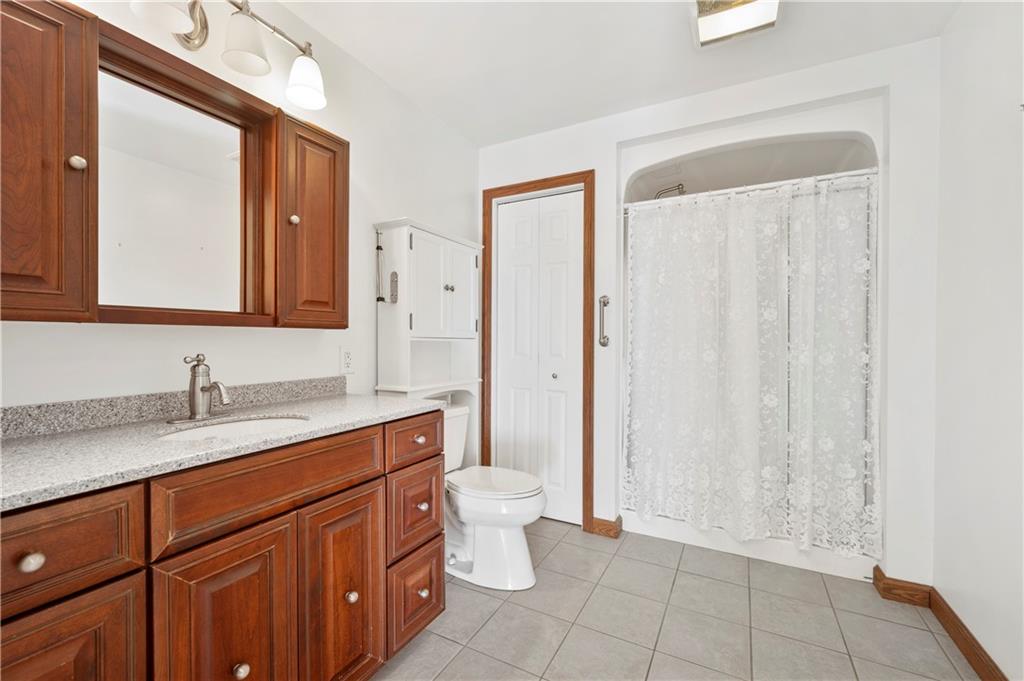 147 Ralston Road Sarver, PA 16055 - Photo 21 of 39 a bathroom with a granite countertop sink a toilet and a mirror