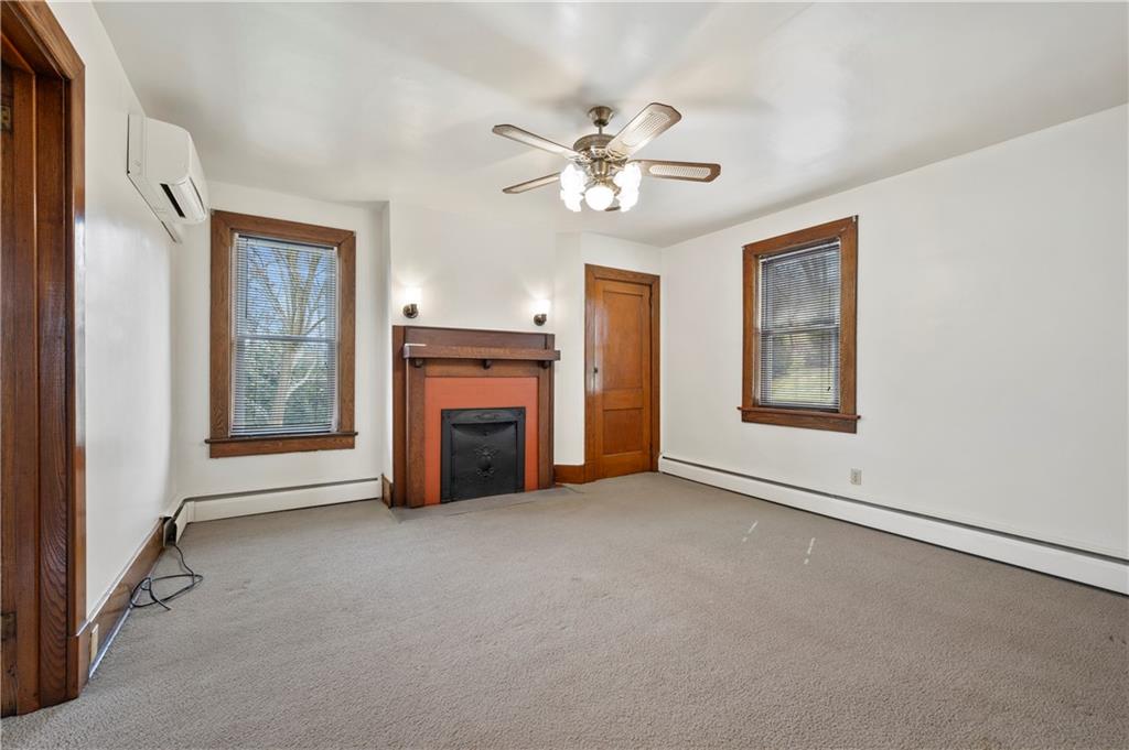 147 Ralston Road Sarver, PA 16055 - Photo 23 of 39 an empty room with windows and fireplace