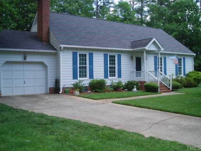 6428 Wynbrook Way Raleigh, NC 27612 - Photo 1 of 6 a front view of a house with a yard and garage