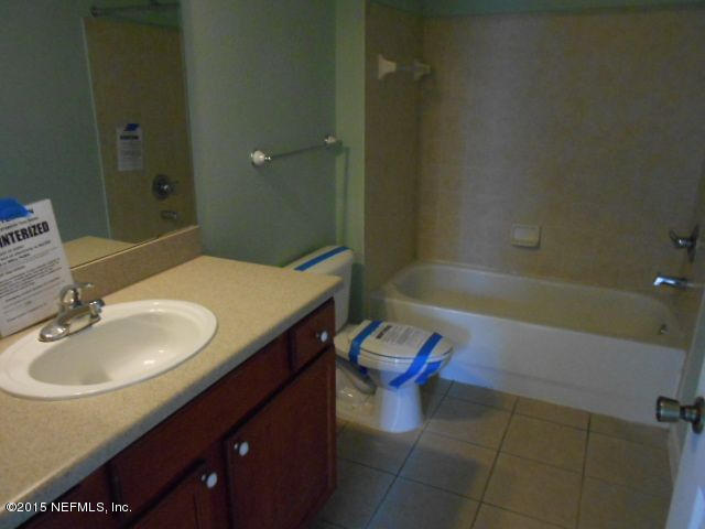 8550 Touchton Road, Unit 1327 Jacksonville, FL 32216 - Photo 13 of 14 a bathroom with a sink and a mirror