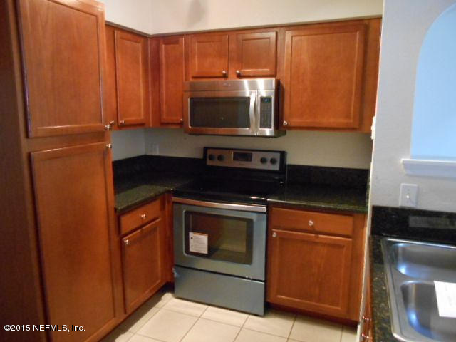 8550 Touchton Road, Unit 1327 Jacksonville, FL 32216 - Photo 5 of 14 a kitchen with stainless steel appliances granite countertop a stove and a microwave