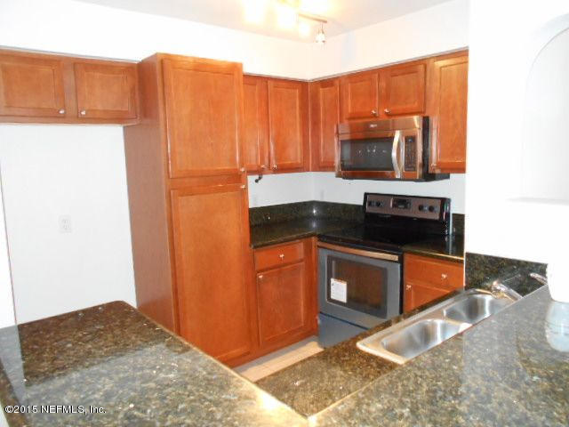 8550 Touchton Road, Unit 1327 Jacksonville, FL 32216 - Photo 6 of 14 a kitchen with a refrigerator and a stove