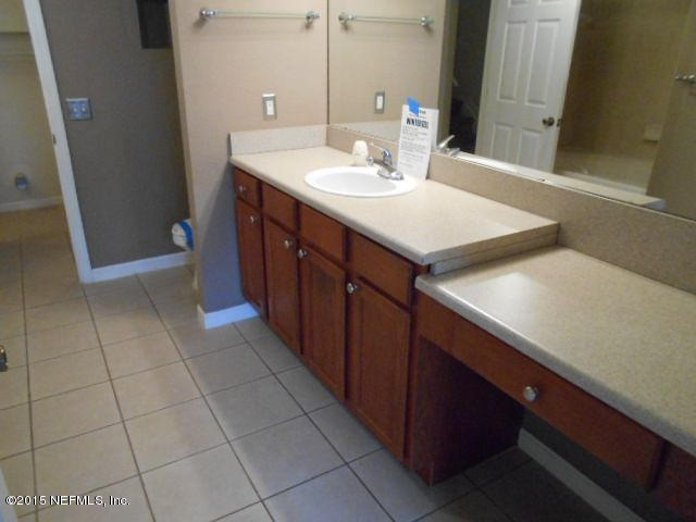 8550 Touchton Road, Unit 1327 Jacksonville, FL 32216 - Photo 10 of 14 a bathroom with a sink and a mirror