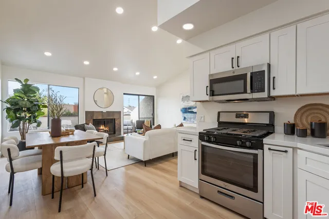 a view of kitchen with sink microwave and cabinets