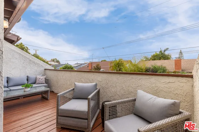 a view of sitting area with couch and potted plant
