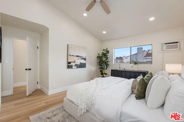 a bedroom with a bed and wooden floor