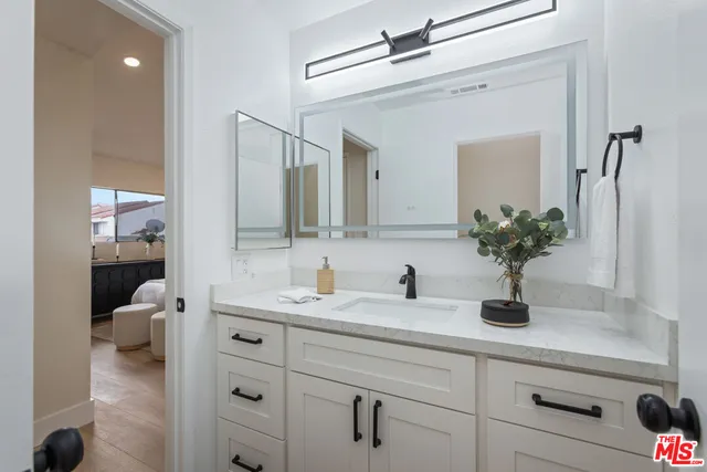 a bathroom with a sink a vanity and a mirror