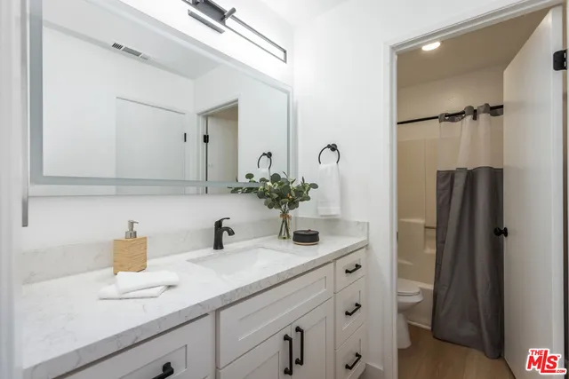 a bathroom with a sink double vanity and a mirror