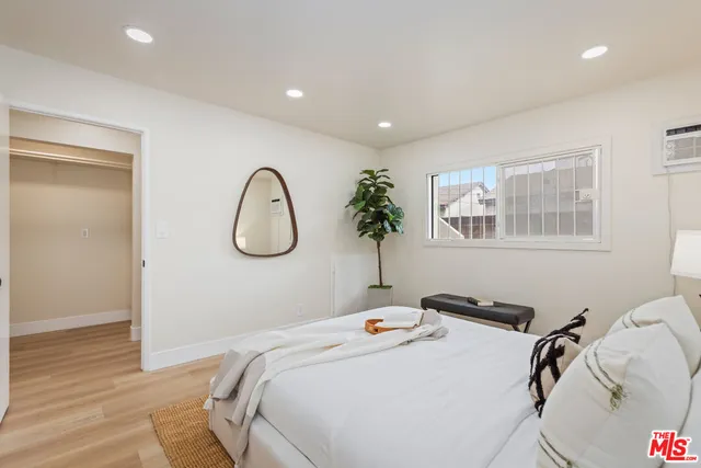 a bedroom with a bed and a window