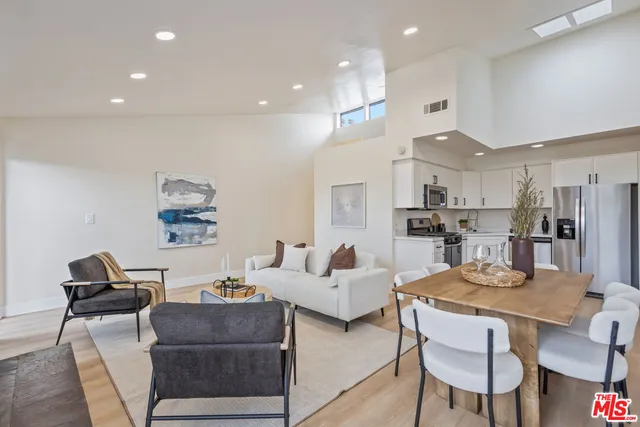 a living room with furniture kitchen and a table