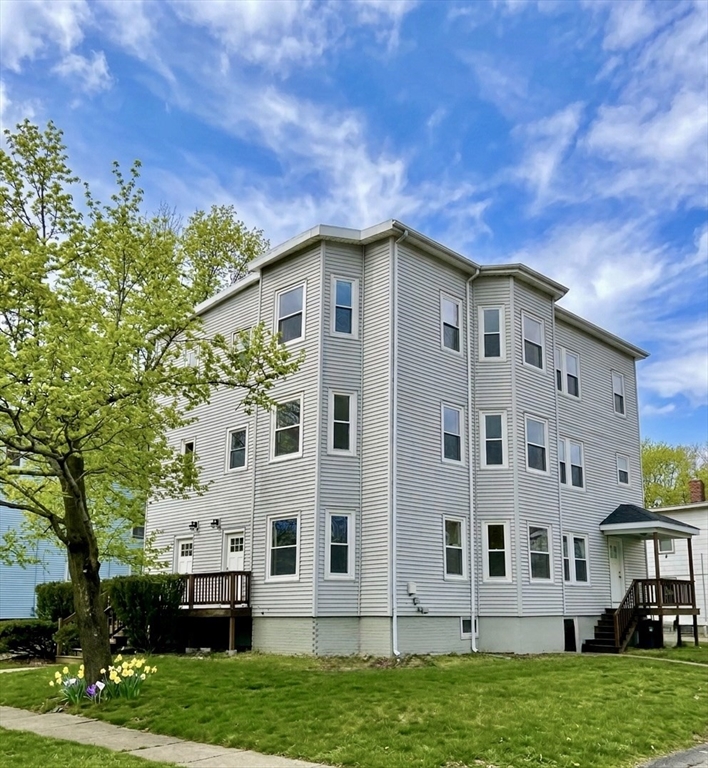 218 Whitman Avenue, Unit 2 Whitman, MA 02382 - Photo 1 of 15 a front view of a house with a yard