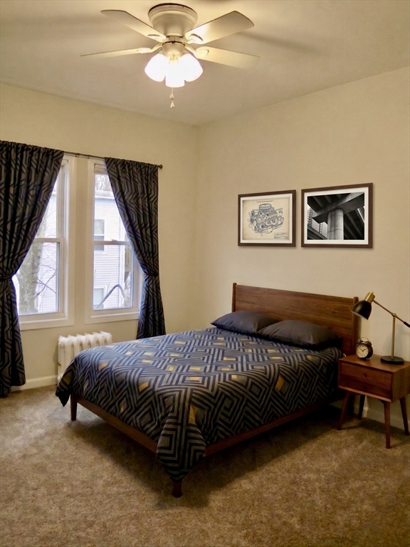 218 Whitman Avenue, Unit 2 Whitman, MA 02382 - Photo 6 of 15 a bedroom with a bed and a large window