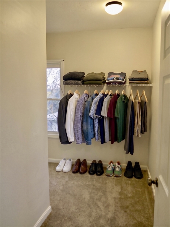 218 Whitman Avenue, Unit 2 Whitman, MA 02382 - Photo 7 of 15 a view of walk in closet with clothes and shoes