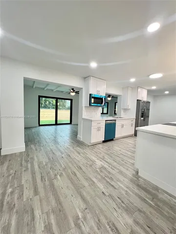 a view of a kitchen with a sink and a large window