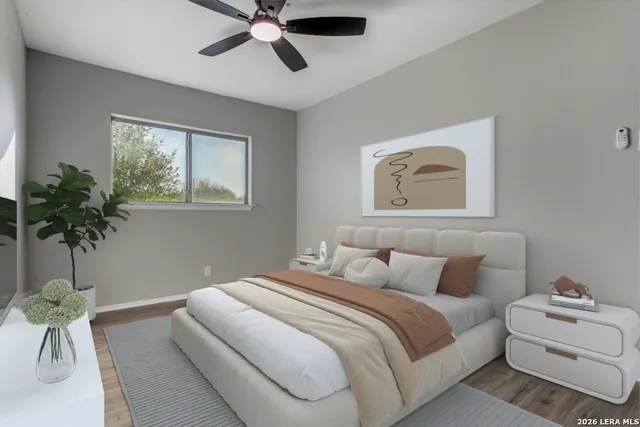 a bedroom with a bed and a potted plant