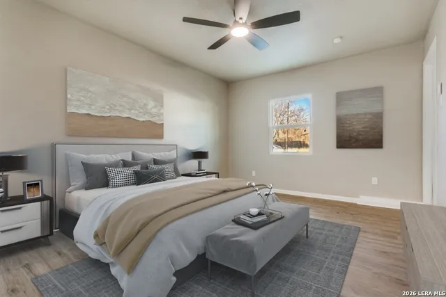 a bedroom with bed and a painting on the wall