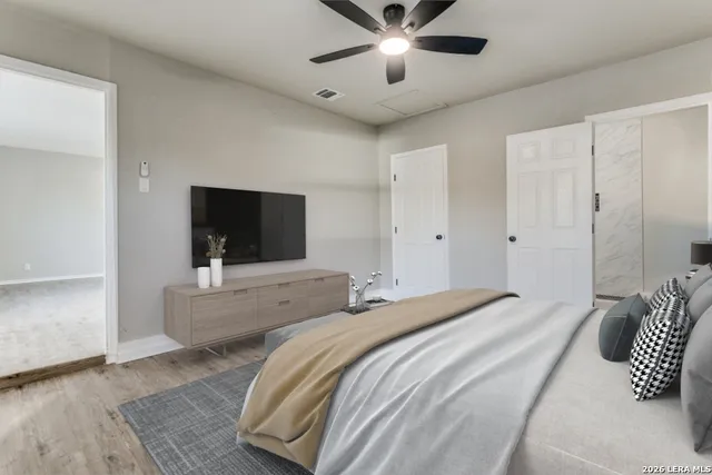 a bedroom with a bed and a flat screen tv