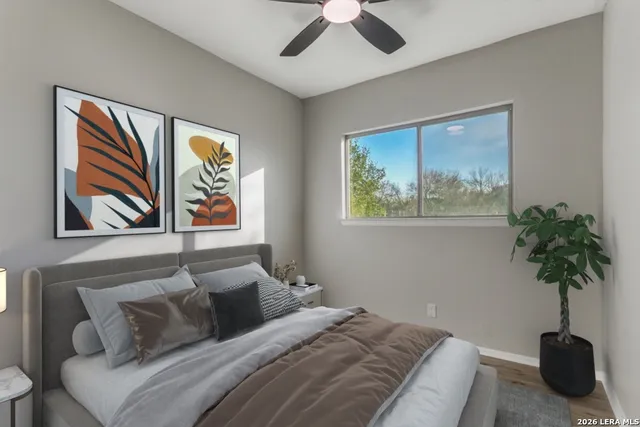 a bedroom with a bed and a potted plant