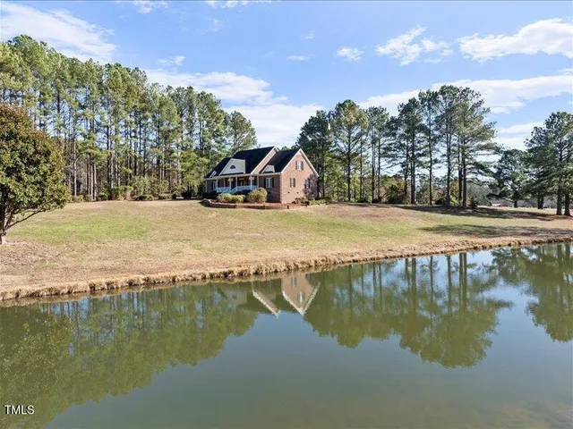 a view of a lake with a house in the background