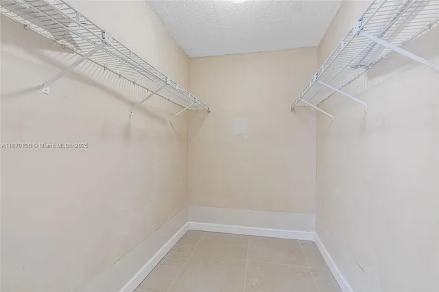 an empty room with a ceiling fan and a window