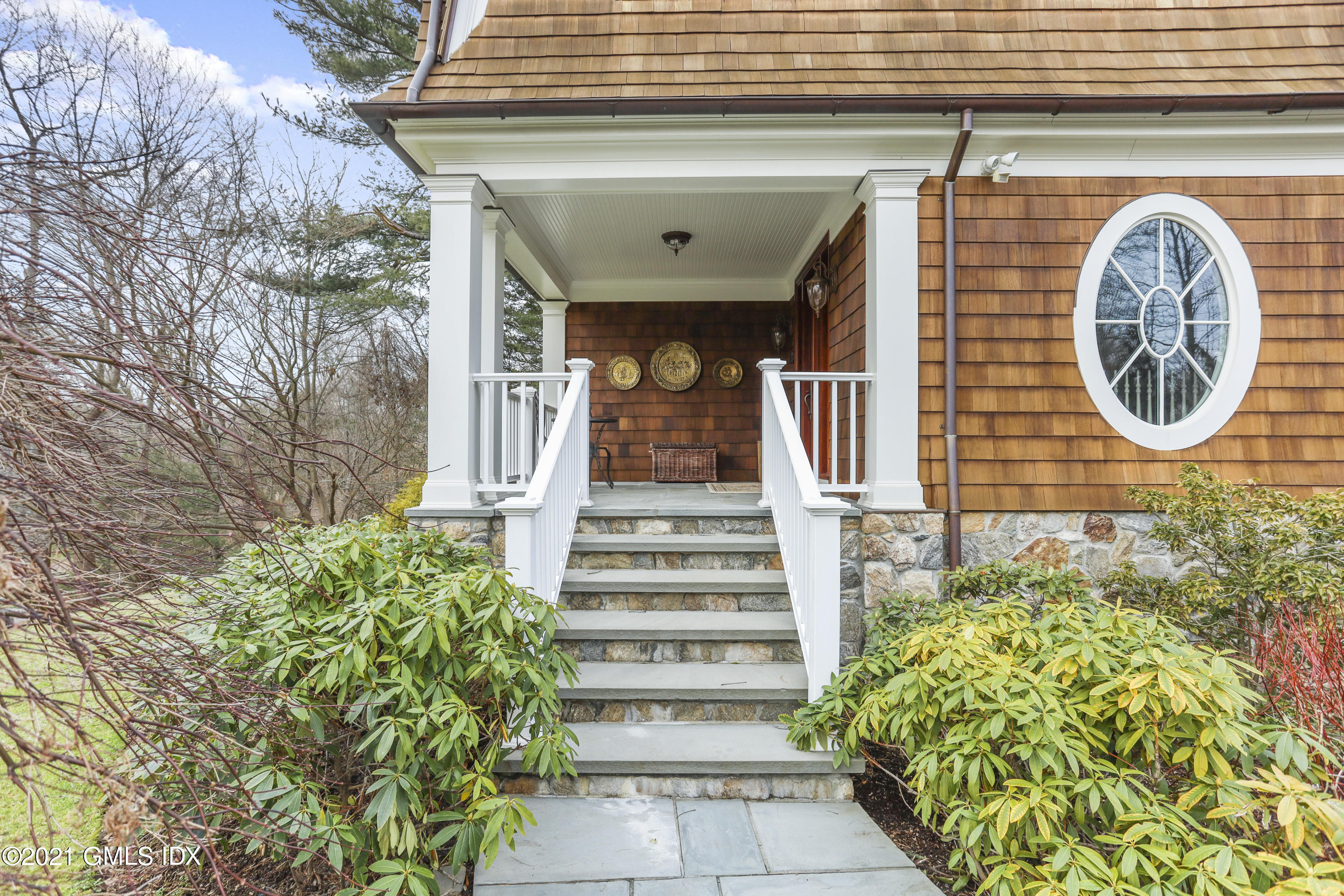 265 Riversville Road Greenwich, CT 06831 - Photo 3 of 47 a front view of a house with plants