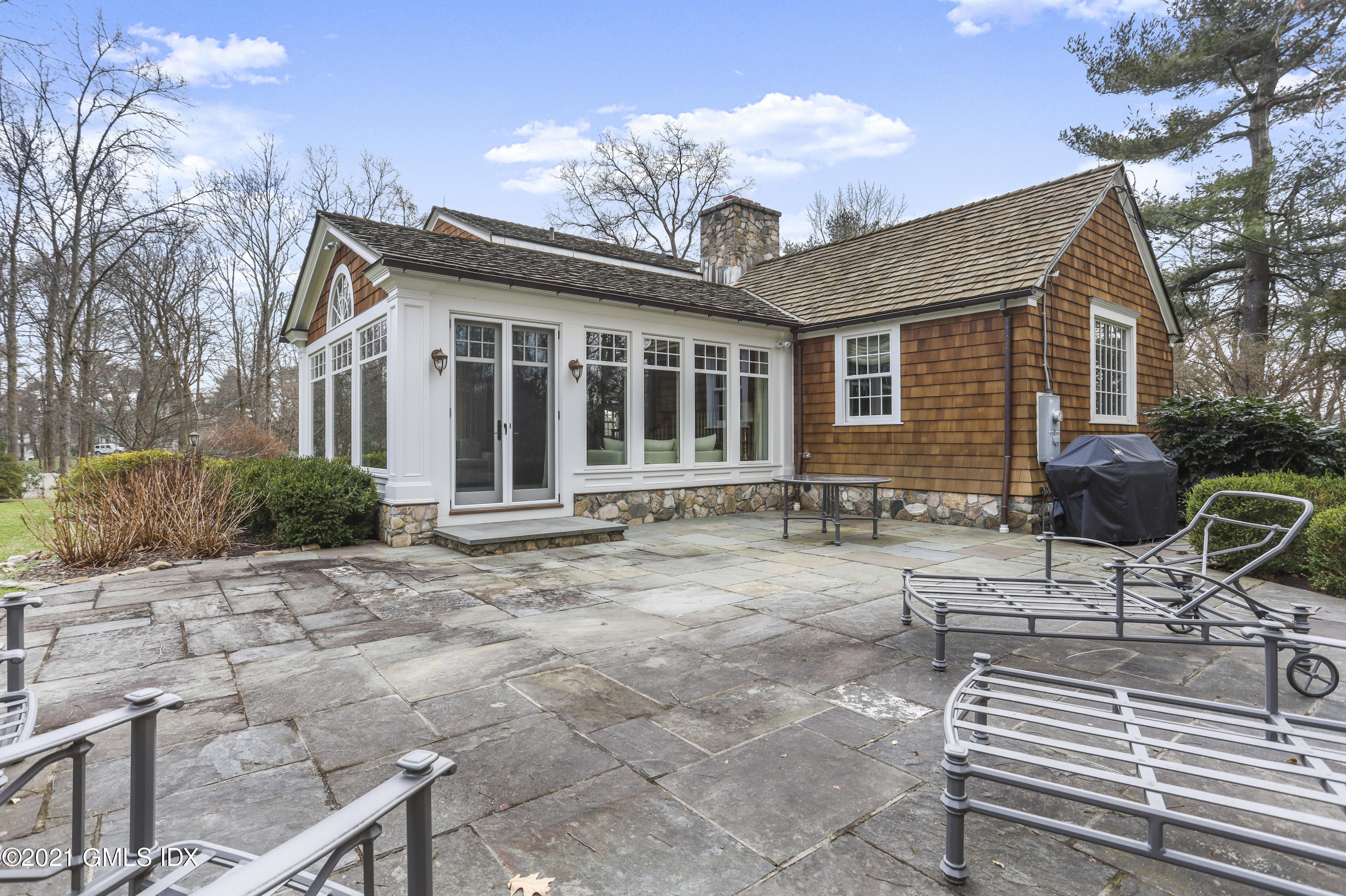 265 Riversville Road Greenwich, CT 06831 - Photo 39 of 47 a backyard of a house with table and chairs