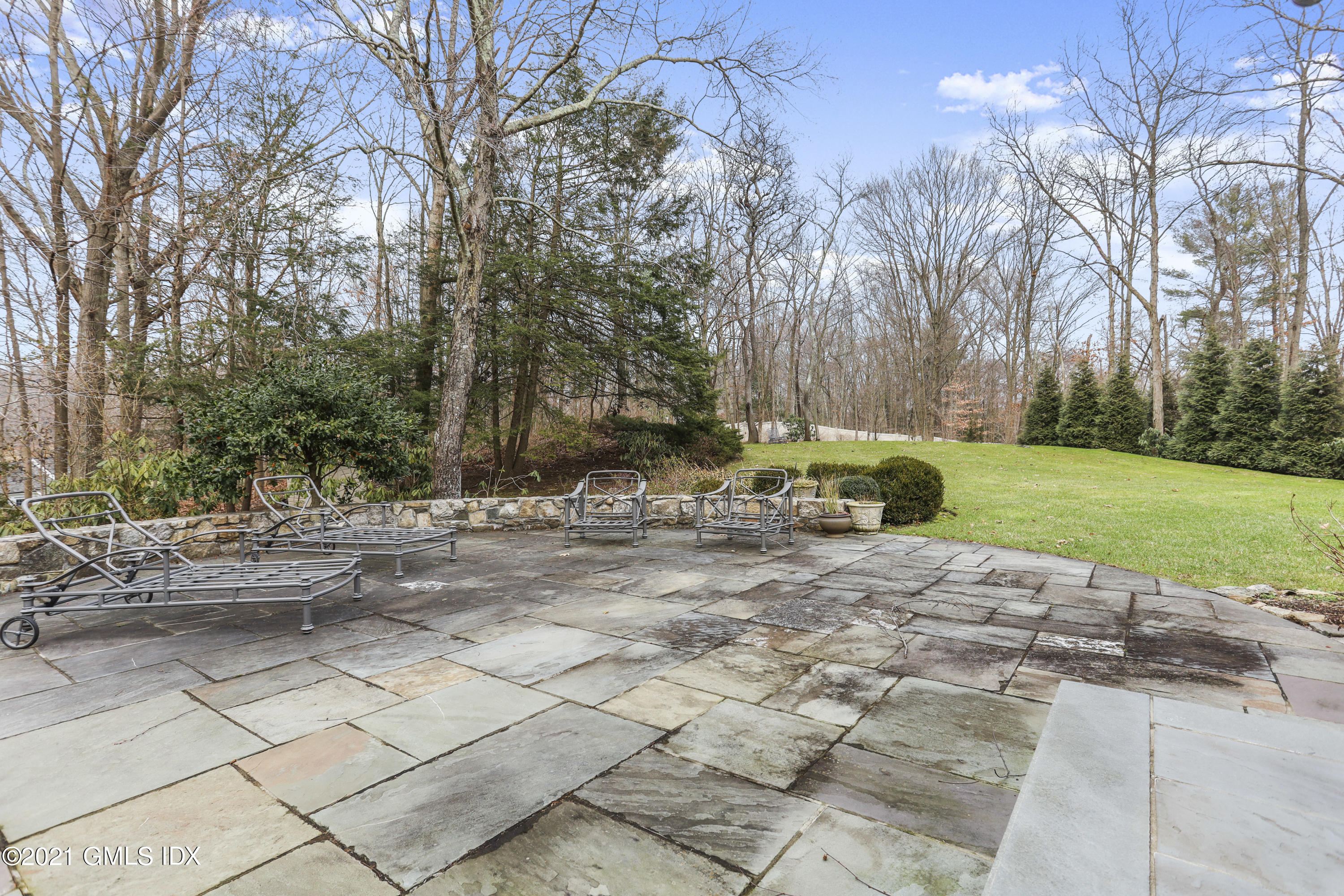 265 Riversville Road Greenwich, CT 06831 - Photo 40 of 47 a view of backyard with table and chairs and couches