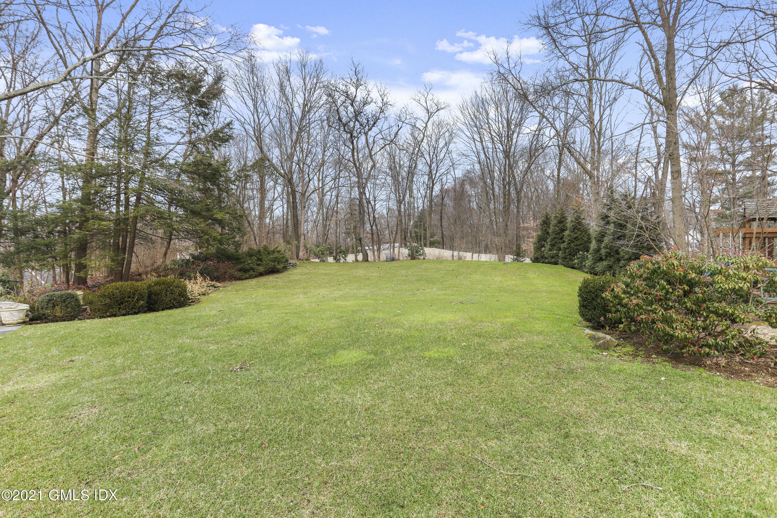 265 Riversville Road Greenwich, CT 06831 - Photo 41 of 47 a backyard of a house with lots of green space
