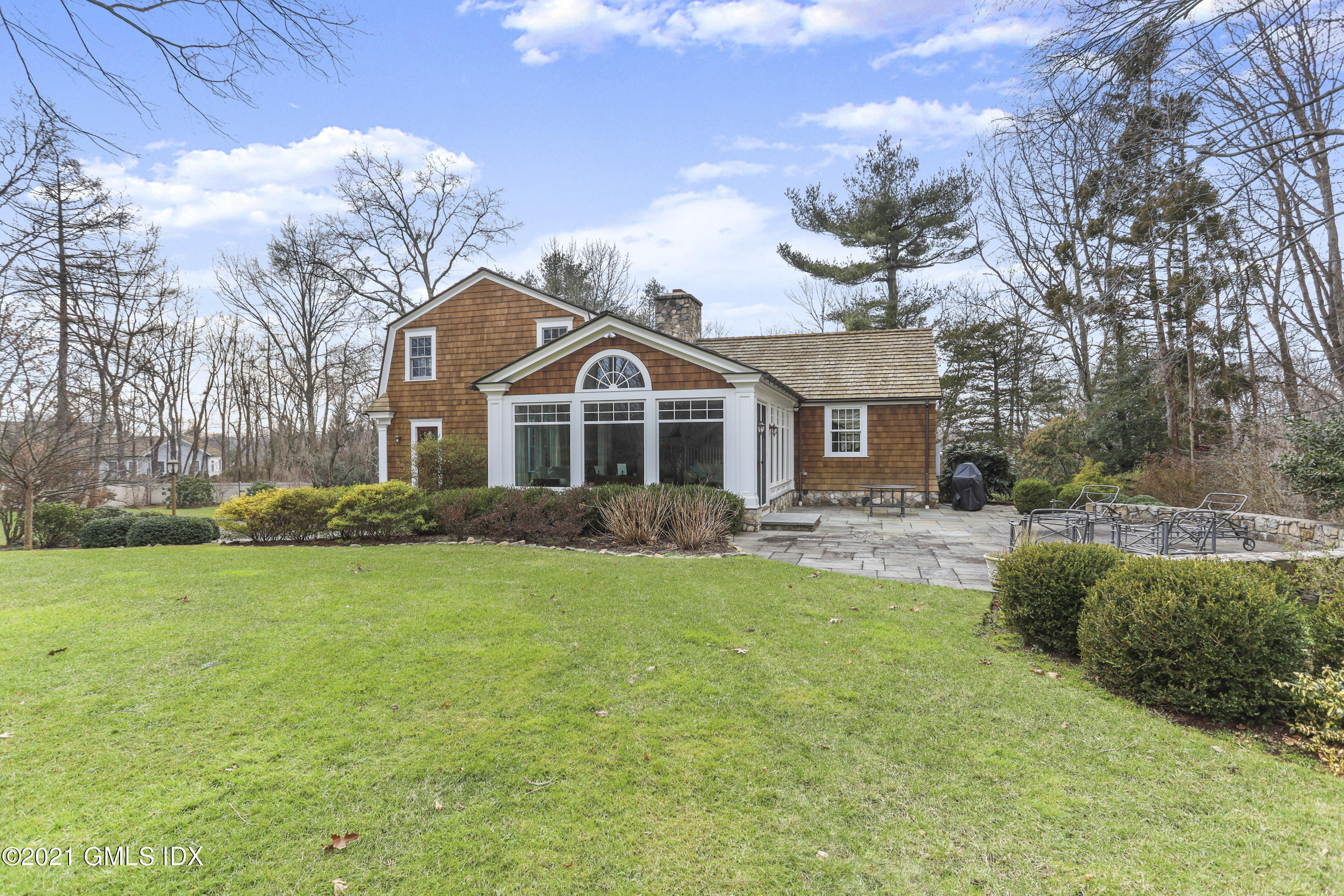 265 Riversville Road Greenwich, CT 06831 - Photo 42 of 47 a front view of a house with a garden